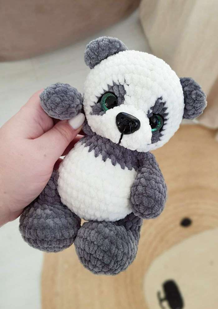 Original Baby Panda sample photograph from the crochet pattern PDF, showing its face, grey paws and white belly.