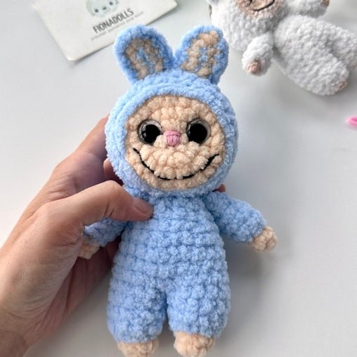 Original finished blue bunny-suit sample, with long ears and an embroidered smile.